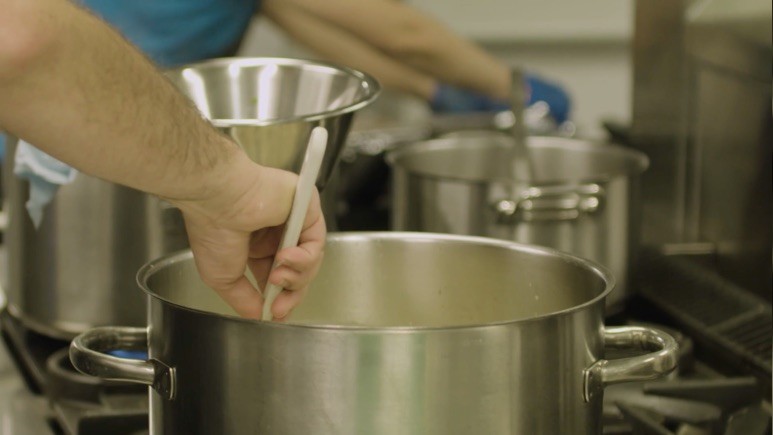 Chef stirring soup