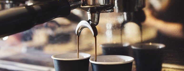 Coffee poured from a machine Coffee poured from a machine